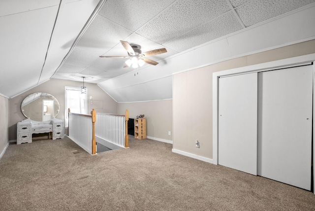 additional living space with vaulted ceiling, ceiling fan, and carpet floors