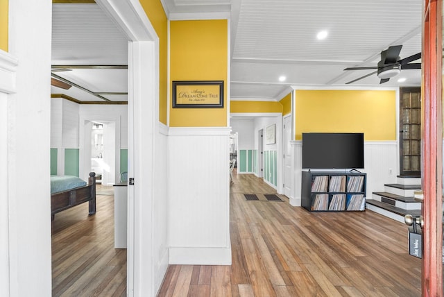 hallway with hardwood / wood-style flooring and crown molding