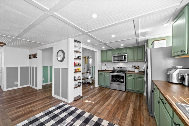 kitchen featuring dark wood-type flooring, green cabinetry, appliances with stainless steel finishes, and butcher block counters