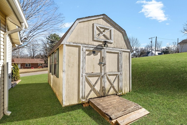 view of outbuilding with a yard