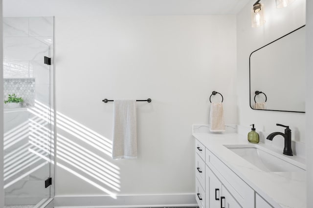 bathroom with vanity and a shower with shower door