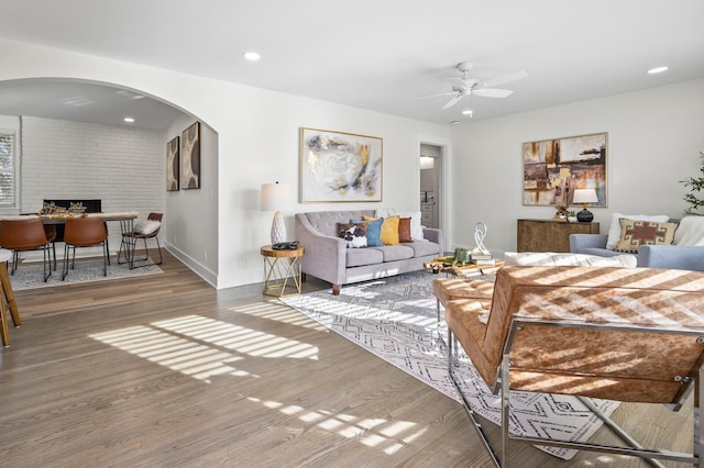 living room with hardwood / wood-style flooring and ceiling fan