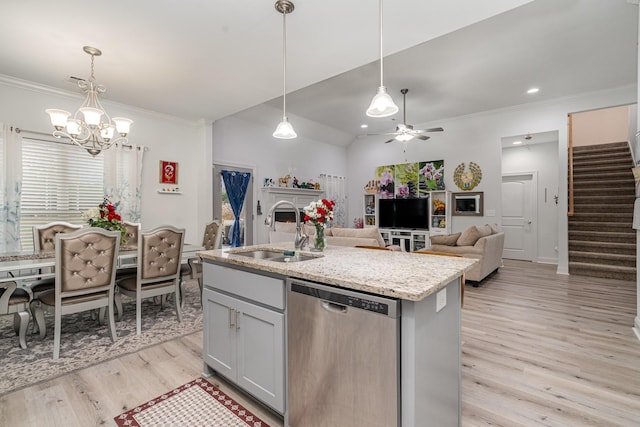 kitchen featuring hanging light fixtures, dishwasher, sink, and a center island with sink