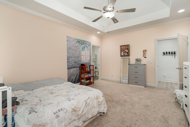 bedroom featuring ceiling fan, light colored carpet, ornamental molding, and a raised ceiling