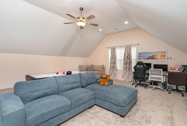 carpeted living room with ceiling fan and vaulted ceiling