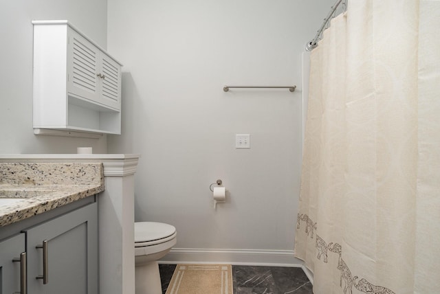 bathroom featuring vanity and toilet