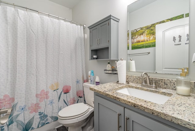 bathroom with walk in shower, vanity, and toilet