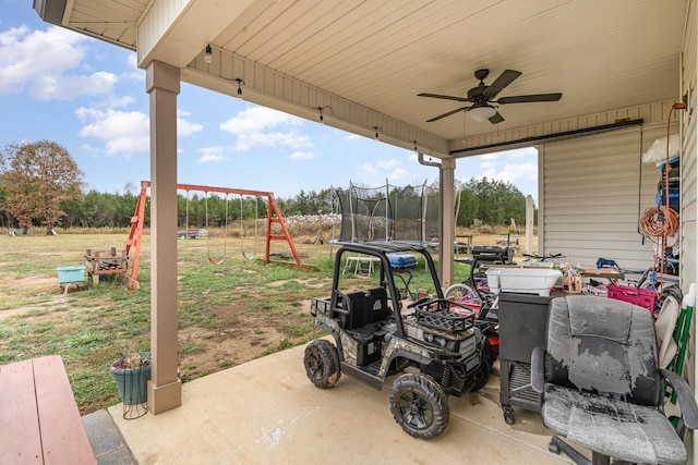 view of patio / terrace with ceiling fan, a playground, and a trampoline