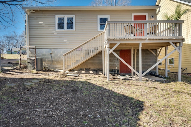 back of property with central AC and a deck