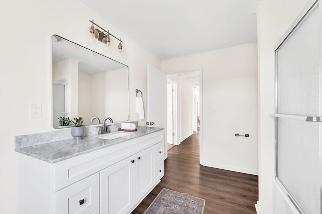 bathroom featuring hardwood / wood-style flooring, vanity, and walk in shower