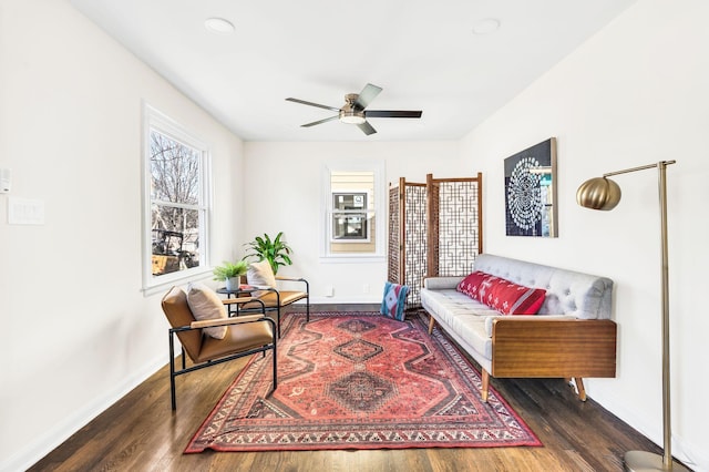 sitting room with dark hardwood / wood-style floors and ceiling fan