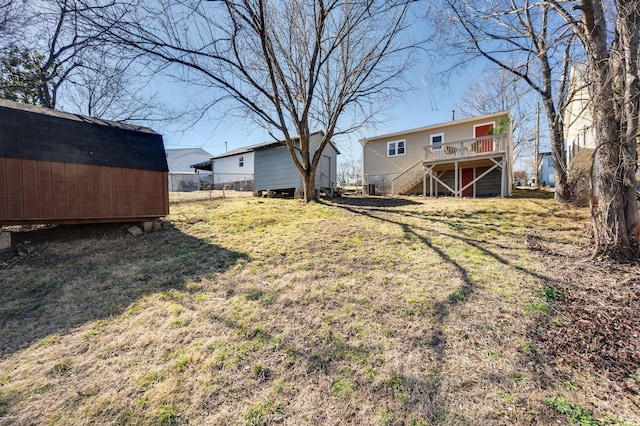 view of yard featuring a shed and a wooden deck