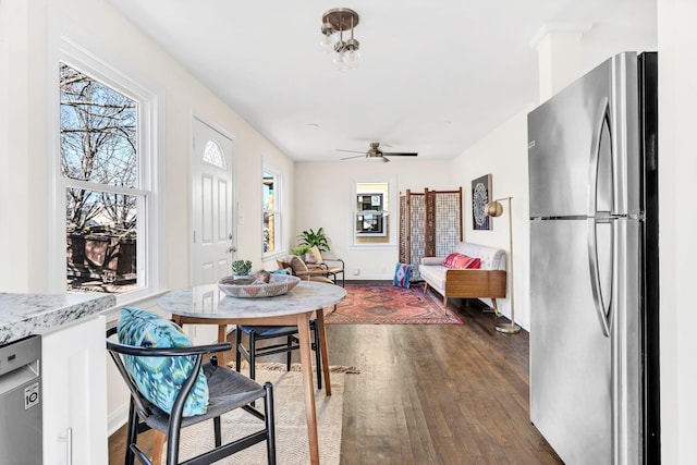 dining space with dark wood-type flooring and ceiling fan