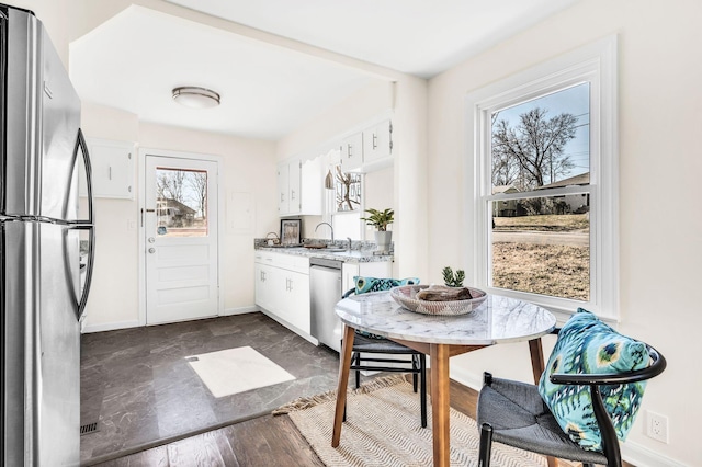 kitchen with stainless steel appliances and white cabinets