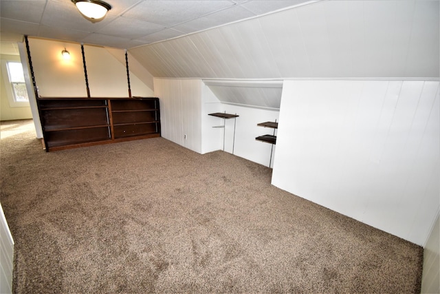 additional living space featuring carpet and lofted ceiling