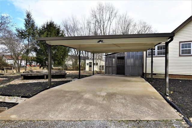 view of patio featuring a carport and a shed