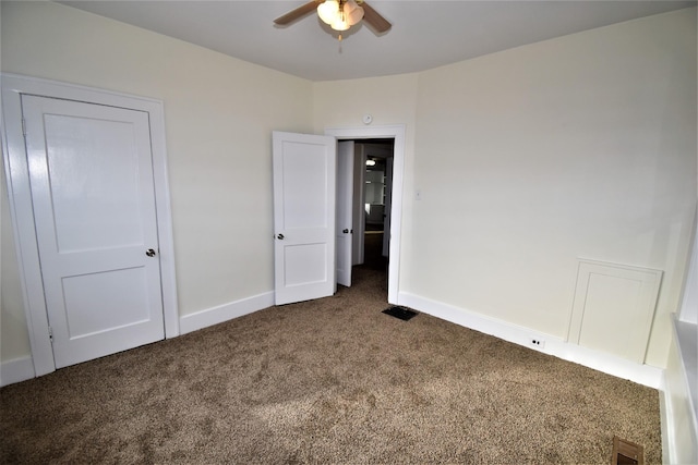 unfurnished bedroom featuring dark carpet