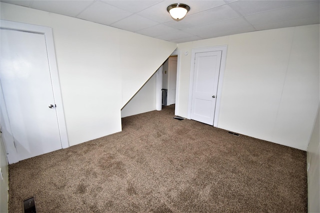 bonus room featuring dark colored carpet