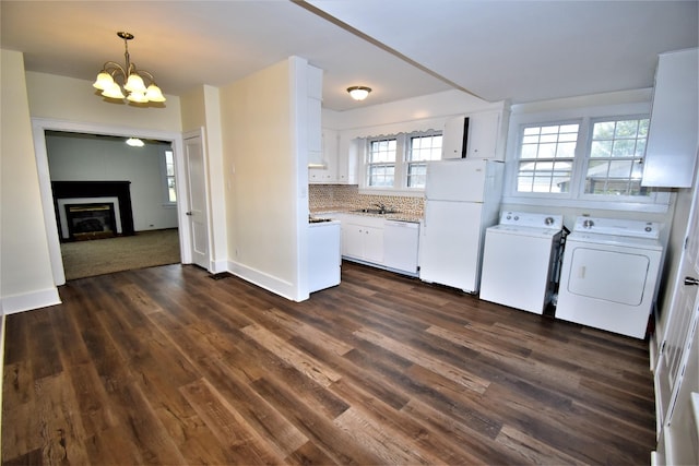 kitchen featuring sink, backsplash, white cabinets, independent washer and dryer, and white appliances