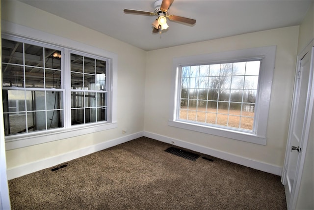 empty room with ceiling fan, a healthy amount of sunlight, and carpet flooring