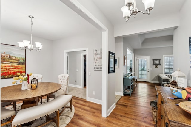 dining space featuring an inviting chandelier and hardwood / wood-style flooring