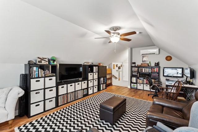 living room with lofted ceiling, ceiling fan, wood-type flooring, and a wall mounted AC