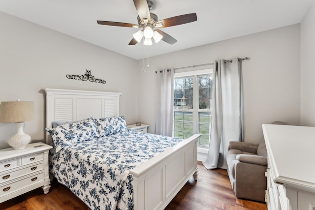 bedroom with dark hardwood / wood-style floors and ceiling fan