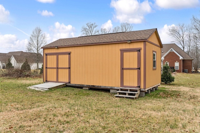 view of outdoor structure with a lawn