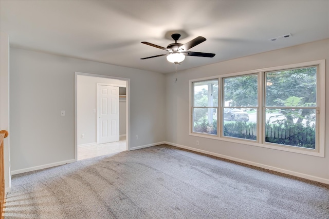 carpeted empty room with ceiling fan