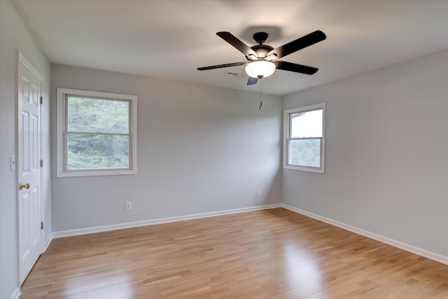 empty room featuring ceiling fan and light wood-type flooring