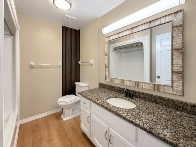 bathroom with vanity, toilet, and hardwood / wood-style floors