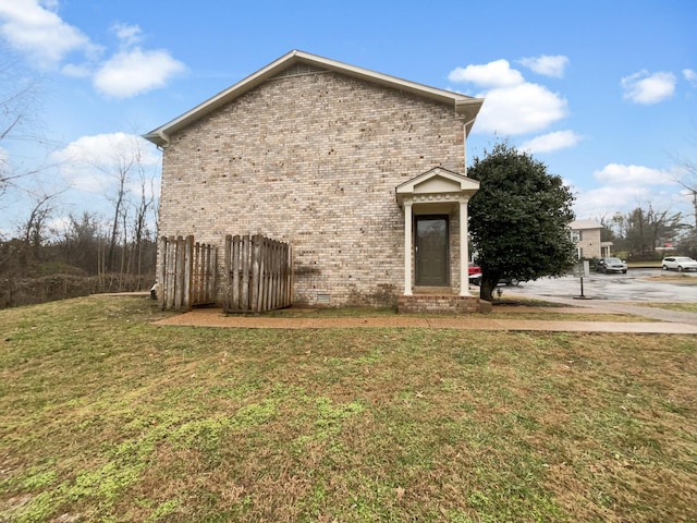 view of side of home featuring a lawn