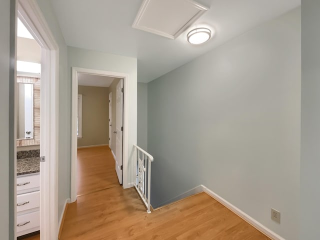 corridor with light wood-type flooring