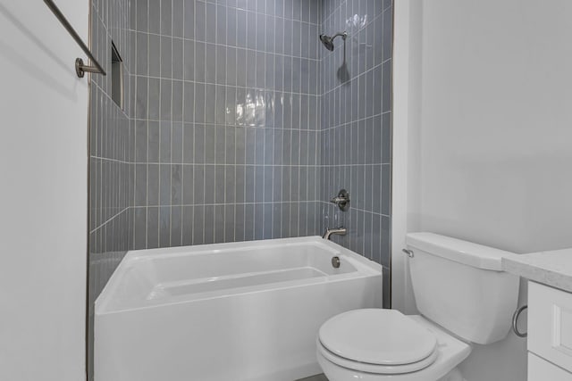 full bathroom featuring vanity, toilet, and tiled shower / bath combo