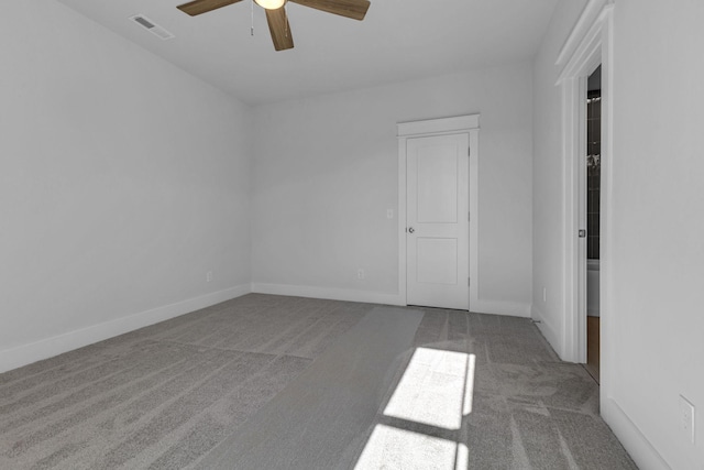 carpeted spare room with ceiling fan