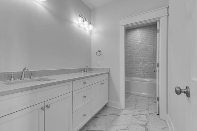 bathroom with tiled shower / bath combo and vanity