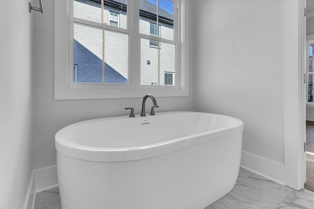 bathroom with a tub to relax in