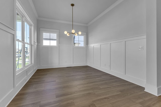 unfurnished dining area with crown molding, a notable chandelier, and dark hardwood / wood-style flooring