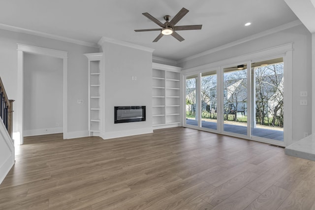 unfurnished living room with ceiling fan, ornamental molding, heating unit, and light hardwood / wood-style flooring