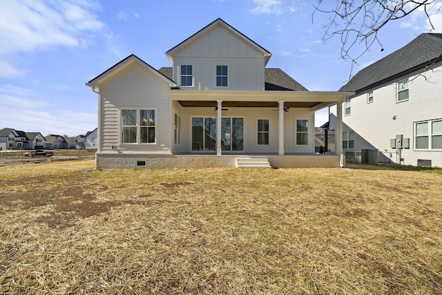 back of property with ceiling fan, a patio area, and a lawn