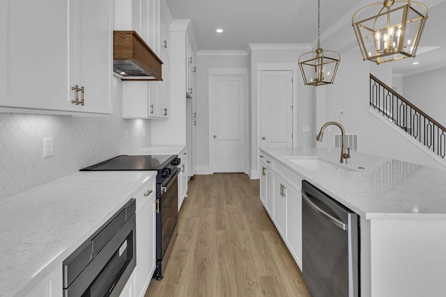 kitchen featuring sink, electric range oven, white cabinets, decorative light fixtures, and stainless steel dishwasher