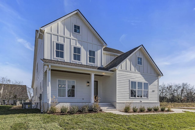 view of front of property featuring a porch, central AC unit, and a front lawn