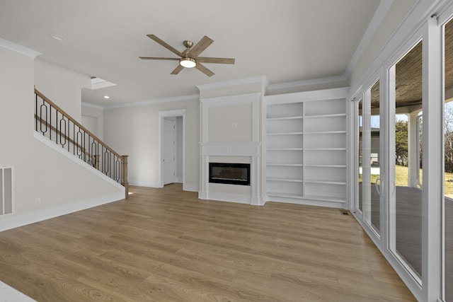 unfurnished living room with ornamental molding, light hardwood / wood-style floors, and ceiling fan