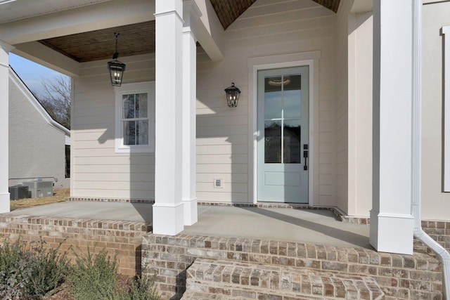 doorway to property featuring central AC and covered porch