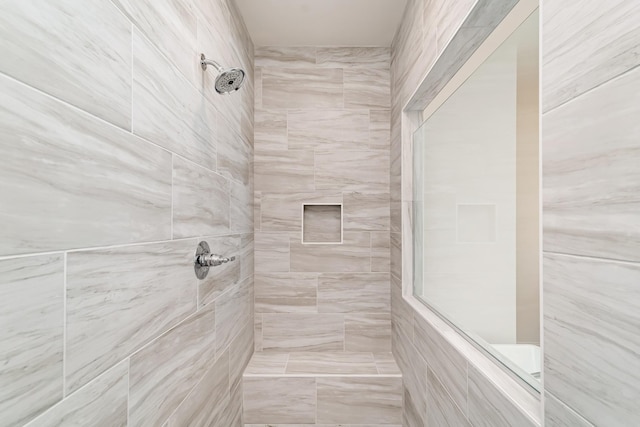 bathroom with a tile shower