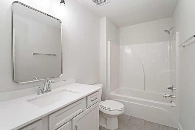 full bathroom with vanity, tile patterned floors, toilet, and washtub / shower combination