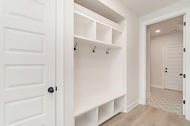 mudroom featuring baseboards and light wood finished floors