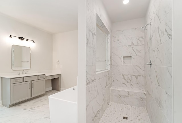 full bathroom featuring a freestanding bath, marble finish floor, a tile shower, and vanity