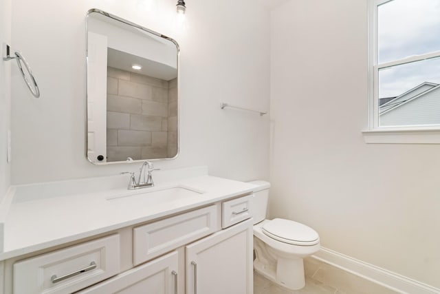 bathroom with tile patterned flooring, vanity, and toilet