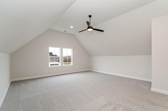 additional living space with a ceiling fan, lofted ceiling, carpet flooring, and baseboards